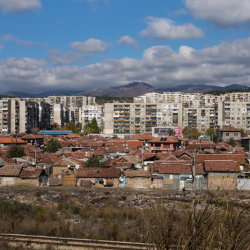 Gypsy Slum, near Kazanlak, with Panelak apartment building in the background.
